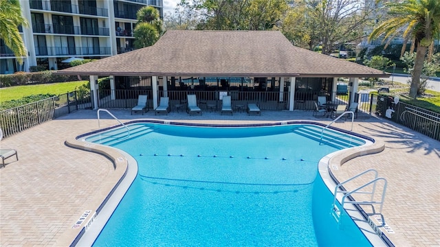 pool featuring a patio and fence