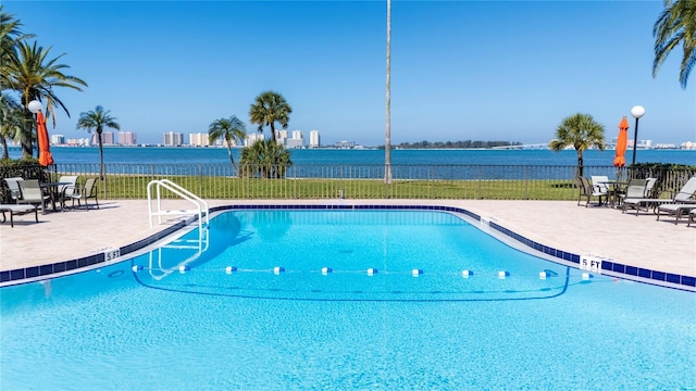 pool with fence and a patio