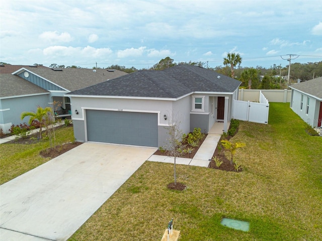 ranch-style home with driveway, a front lawn, fence, and stucco siding