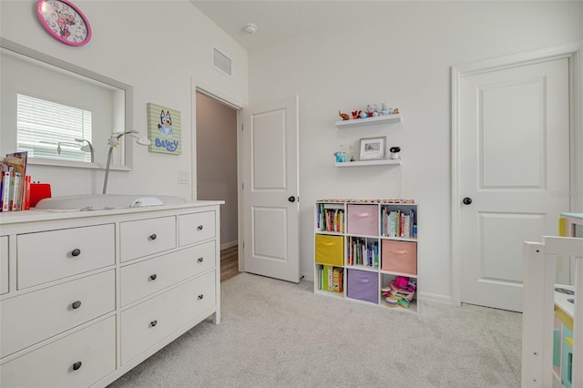 bedroom featuring baseboards, visible vents, and light colored carpet