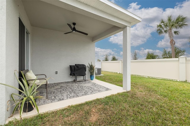 view of yard with central air condition unit, a patio area, a fenced backyard, and a ceiling fan