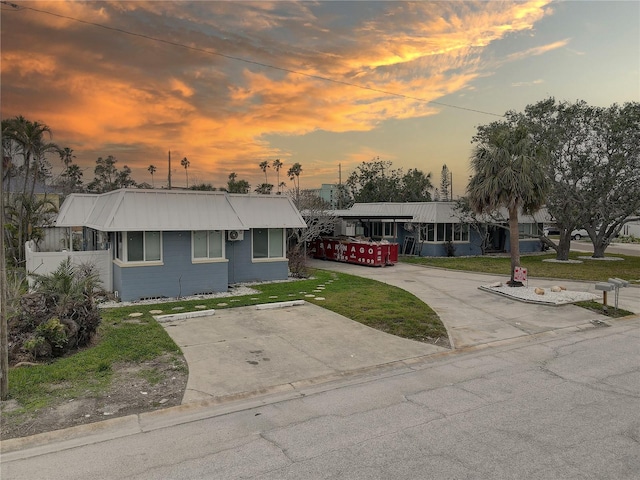 view of front of property with a front lawn and metal roof