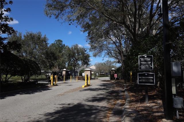 view of street featuring curbs and a gated entry