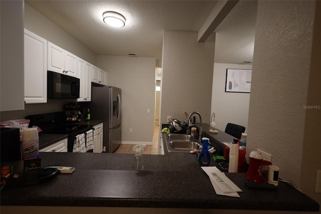 kitchen featuring dark countertops, a sink, a textured ceiling, and black appliances