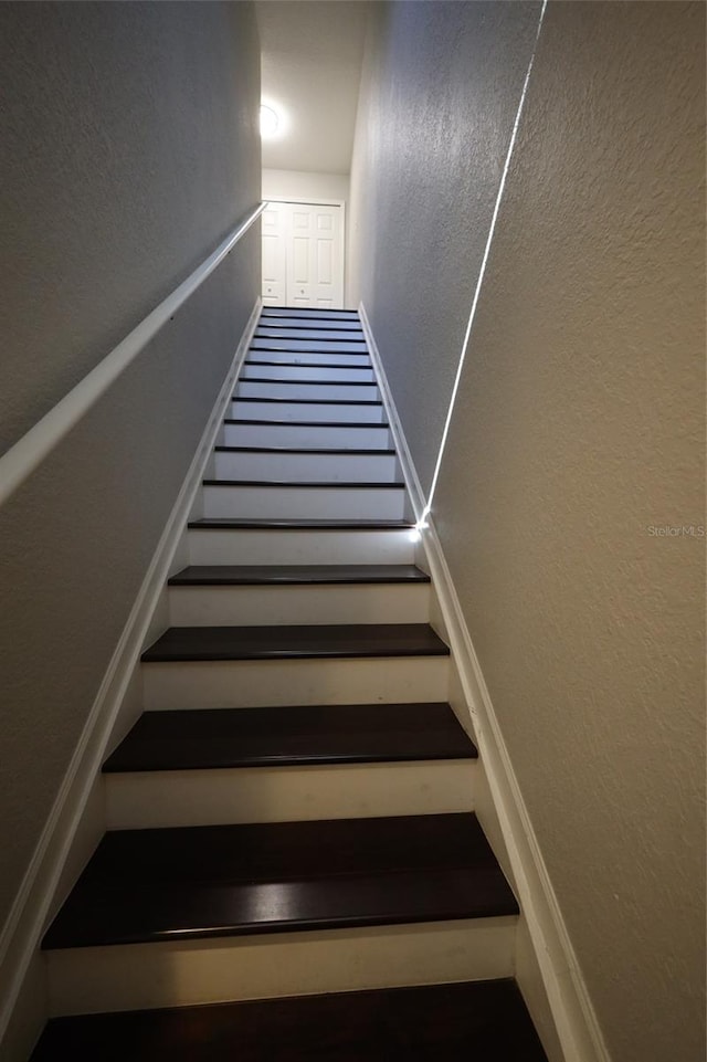 stairway with a textured wall