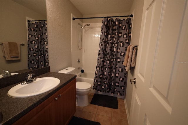 bathroom with a textured wall, toilet, shower / tub combo, vanity, and tile patterned floors