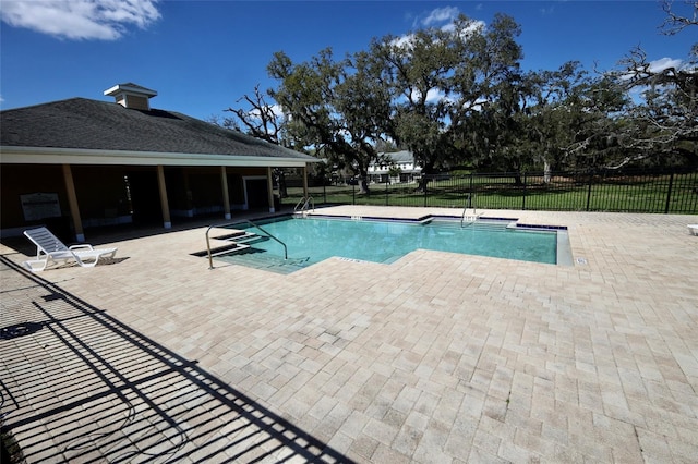 community pool featuring fence and a patio