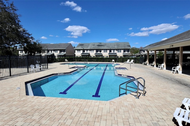 pool featuring fence and a patio