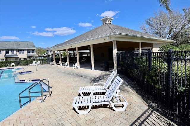 exterior space with fence and a community pool