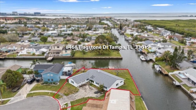 birds eye view of property featuring a water view and a residential view