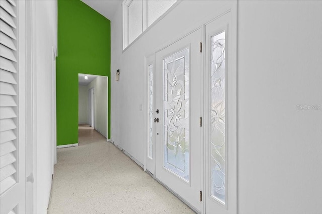 entryway featuring plenty of natural light and baseboards