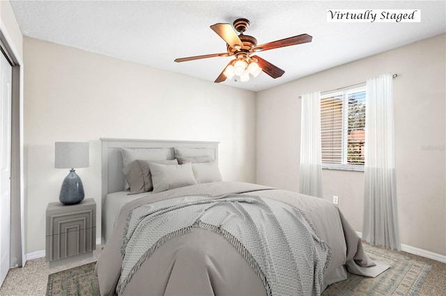 bedroom featuring carpet flooring, a ceiling fan, and baseboards