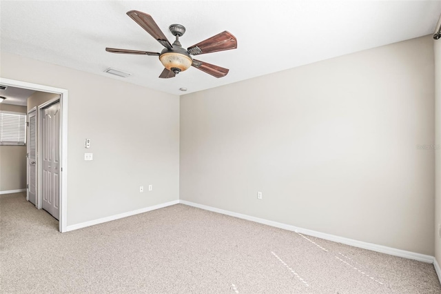 unfurnished bedroom with light carpet, baseboards, visible vents, ceiling fan, and a closet