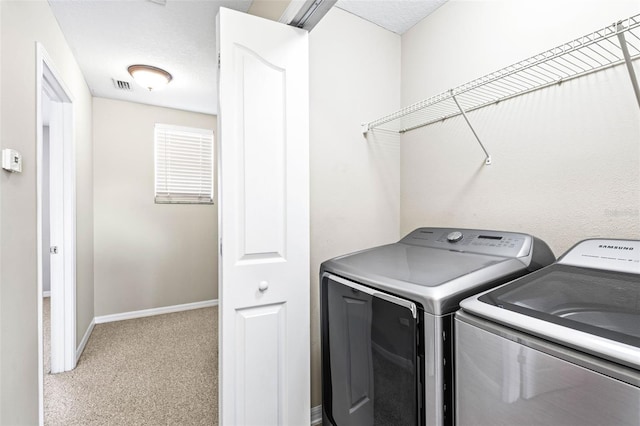 laundry room featuring carpet, visible vents, washer and dryer, laundry area, and baseboards