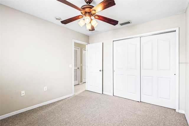 unfurnished bedroom featuring light carpet, visible vents, and baseboards