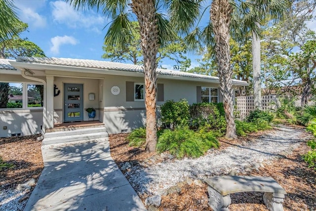 view of front of home with fence and stucco siding