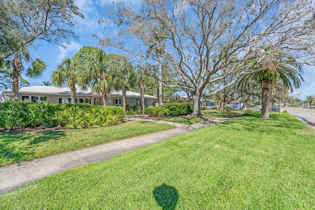 view of home's community with a lawn