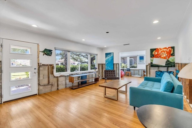 living area with light wood-style flooring and recessed lighting