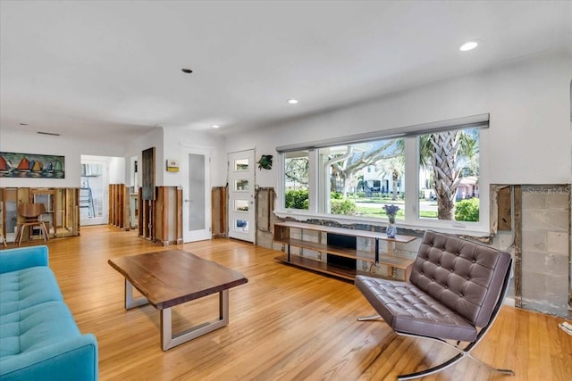 living area featuring wood finished floors and recessed lighting