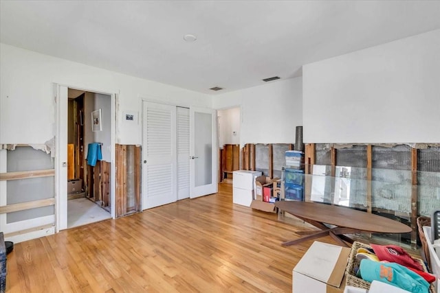 interior space with light wood-style floors and visible vents