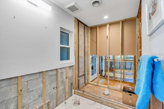 interior space featuring concrete block wall and visible vents