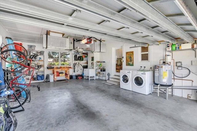 garage with water heater, washer and dryer, and a workshop area