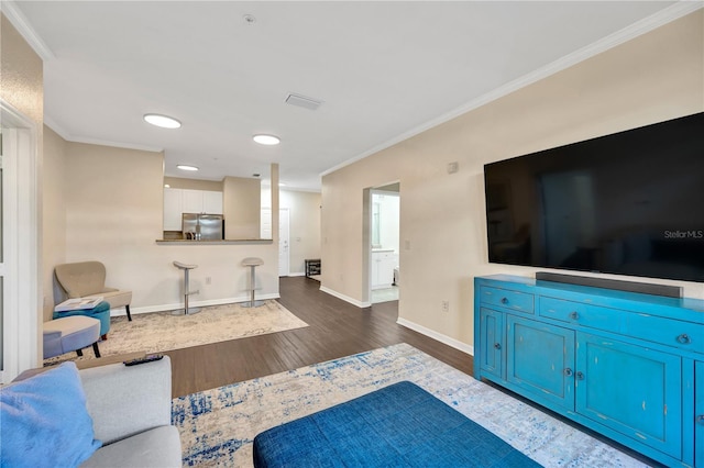 living room featuring baseboards, visible vents, ornamental molding, and dark wood finished floors