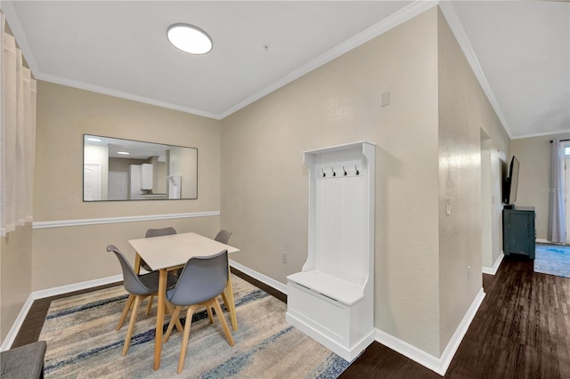 dining room with ornamental molding, dark wood-style flooring, and baseboards