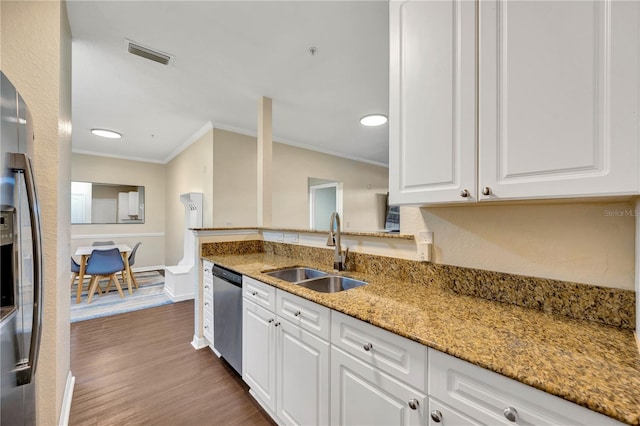 kitchen featuring light stone counters, a sink, visible vents, white cabinetry, and appliances with stainless steel finishes