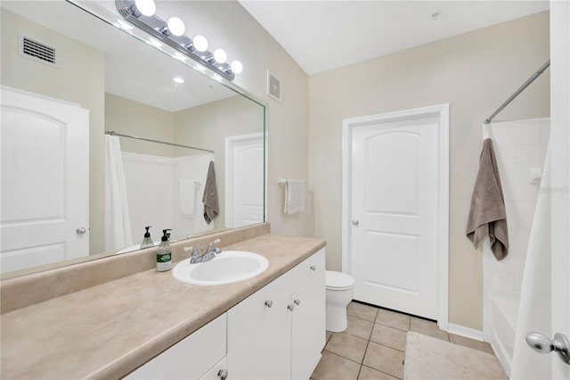 bathroom featuring toilet, vanity, visible vents, and tile patterned floors