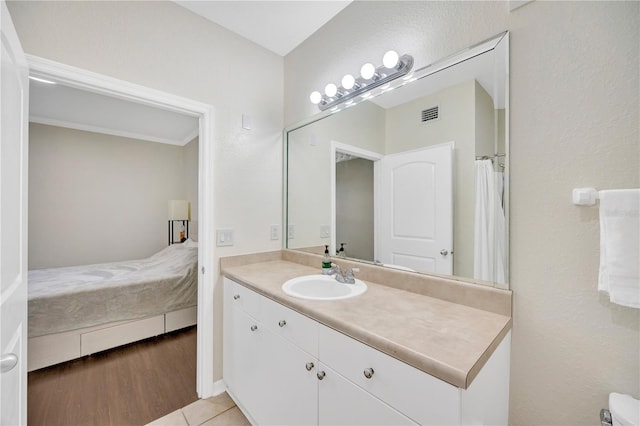 full bathroom with wood finished floors, visible vents, vanity, and ensuite bathroom