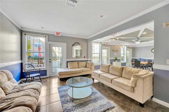 living room featuring a wealth of natural light, visible vents, and baseboards