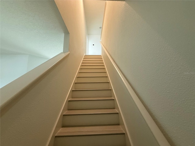 stairs with a textured wall