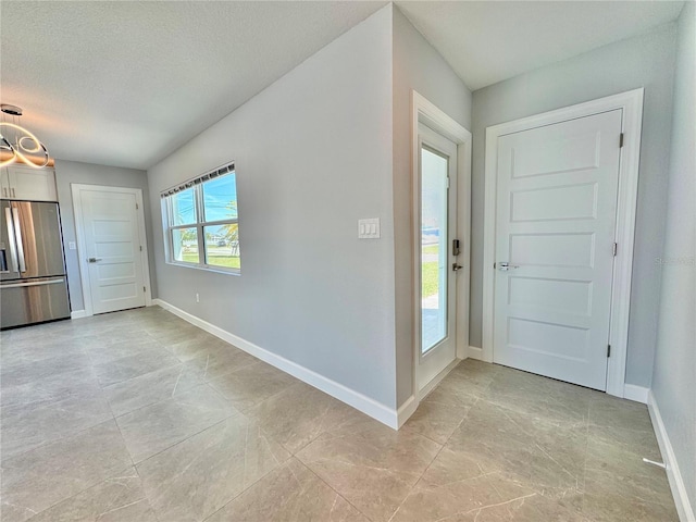 entrance foyer featuring baseboards and a textured ceiling