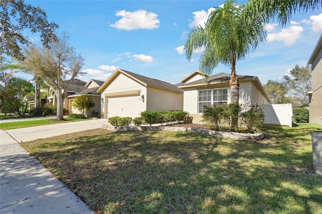 single story home with stucco siding, fence, a garage, driveway, and a front lawn