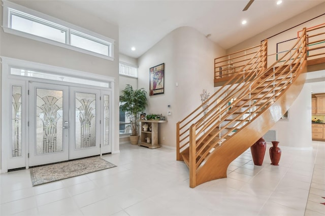 foyer with recessed lighting, french doors, stairway, and a towering ceiling