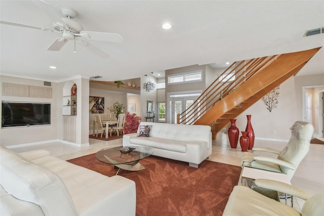 living room featuring light tile patterned floors, recessed lighting, a ceiling fan, visible vents, and stairway