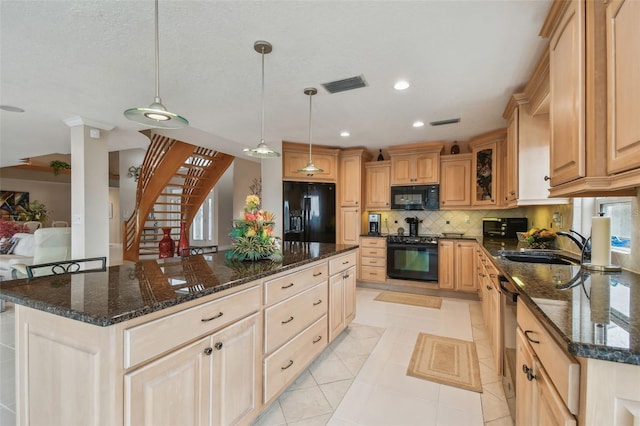 kitchen with visible vents, backsplash, a center island, black appliances, and a sink