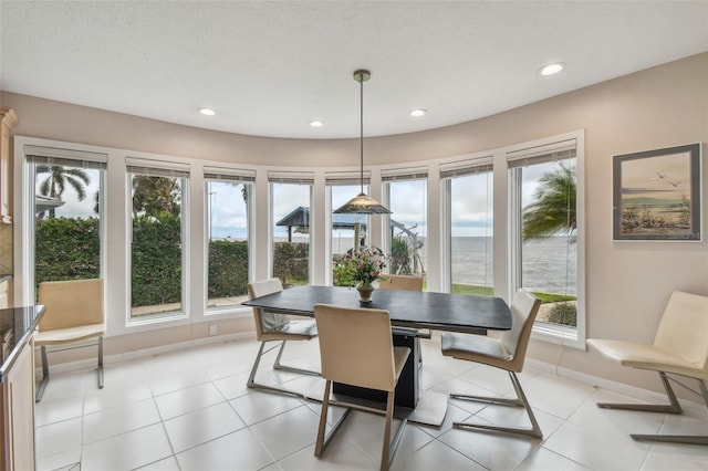 dining area featuring light tile patterned floors, baseboards, and recessed lighting