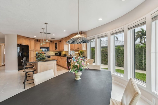 dining room featuring recessed lighting, baseboards, and light tile patterned flooring