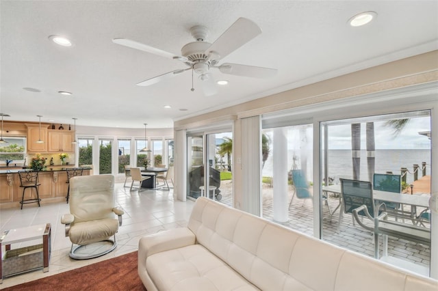 living area featuring light tile patterned floors, a ceiling fan, and recessed lighting