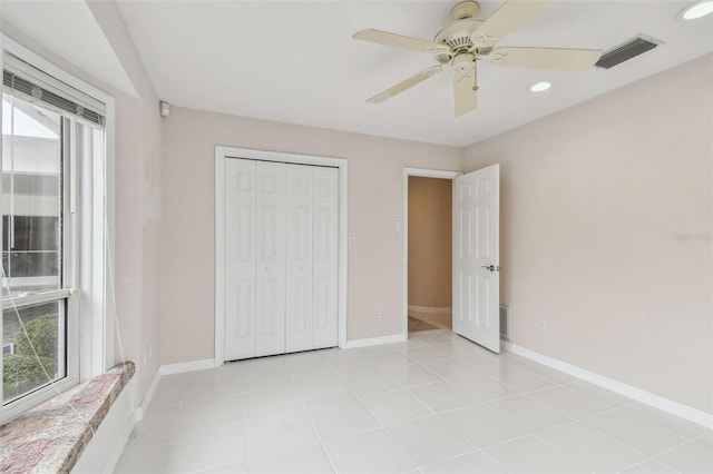 unfurnished bedroom featuring light tile patterned floors, baseboards, visible vents, and recessed lighting