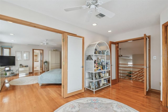 bedroom with recessed lighting, visible vents, ceiling fan, wood finished floors, and baseboards