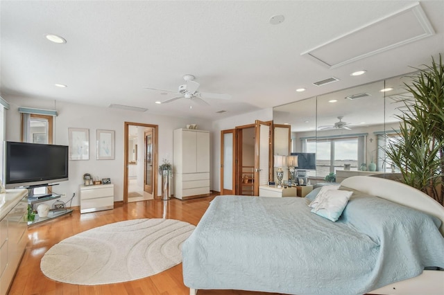 bedroom featuring attic access, visible vents, wood finished floors, and recessed lighting