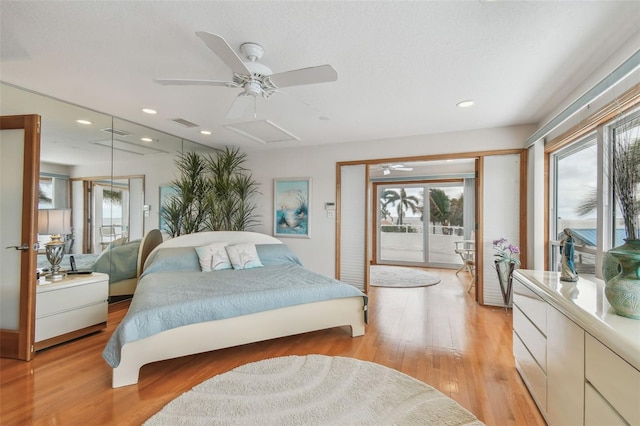 bedroom with light wood finished floors, attic access, visible vents, access to exterior, and recessed lighting