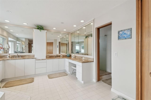 bathroom featuring recessed lighting, a sink, and double vanity