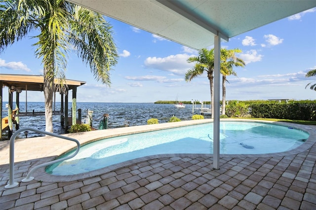 pool with a water view and a patio area