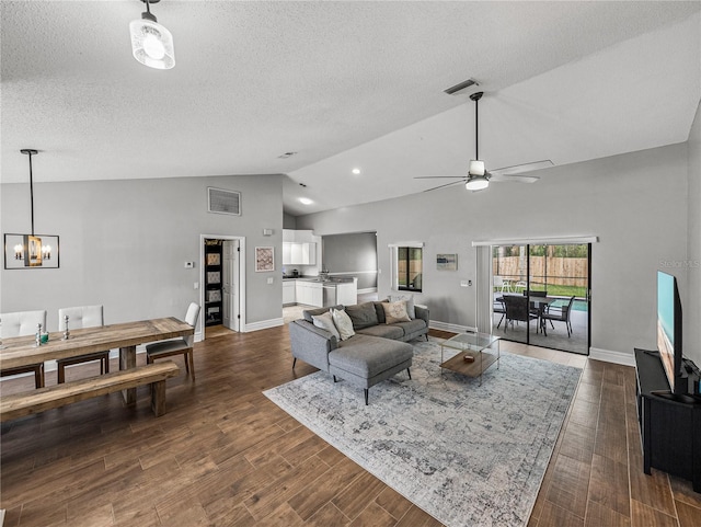 living area featuring a textured ceiling, baseboards, vaulted ceiling, and dark wood-style flooring