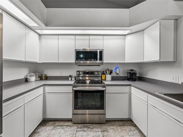 kitchen with white cabinets, stainless steel appliances, and a sink