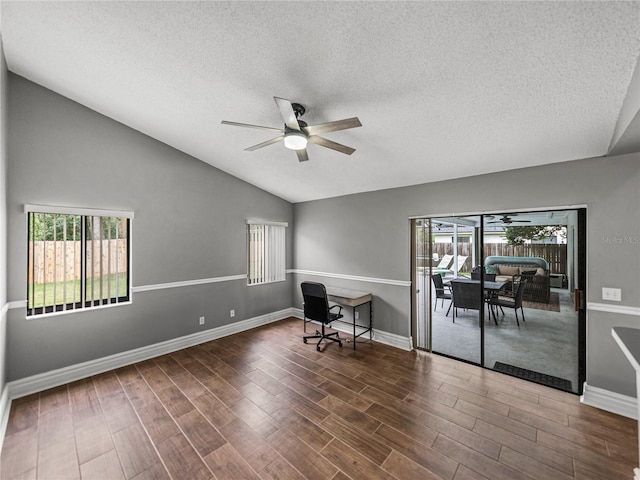 unfurnished office featuring ceiling fan, baseboards, vaulted ceiling, and wood finished floors